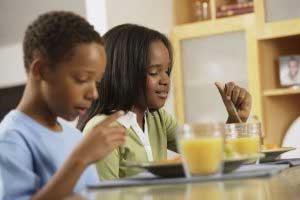 boy and girl eating breakfast