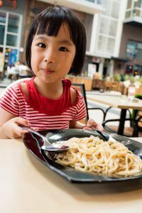 girl eating noodles