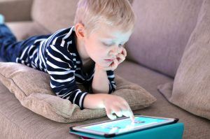 boy on couch with tablet