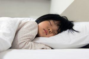 girl tucked in bed asleep