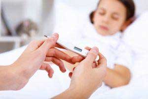 parent taking sick boys temperature