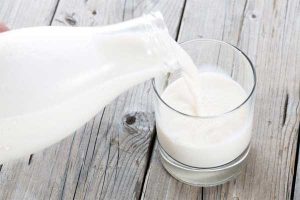 pouring milk from bottle to glass