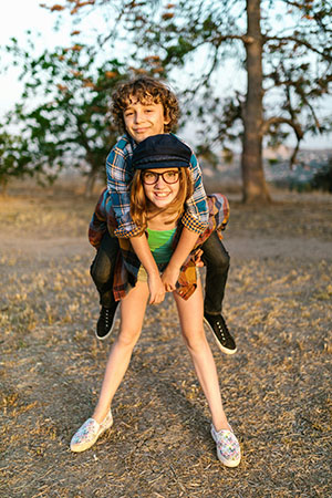 brother riding on sisters back