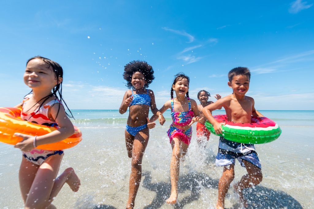 Group of Diversity Children playing on a tropical beach